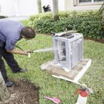 HVAC repairman cleans unit