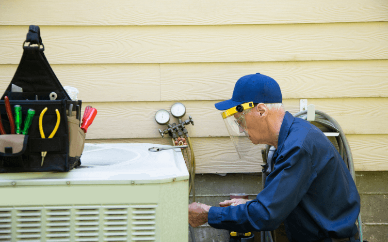 repair man working on air conditioner