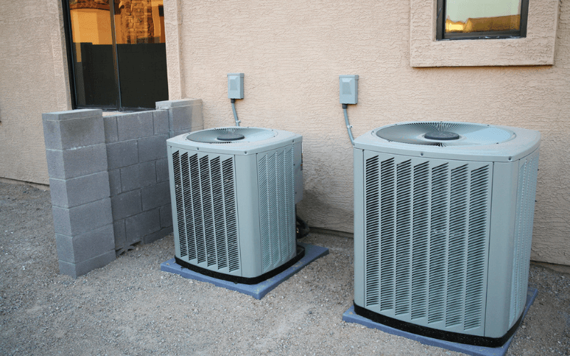 if you are selling your house your HVAC can impact your home value. Two air conditioners side by side, one new and one old.